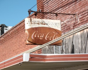 Old Coca-Cola sign outside general store, Commerce, OK.